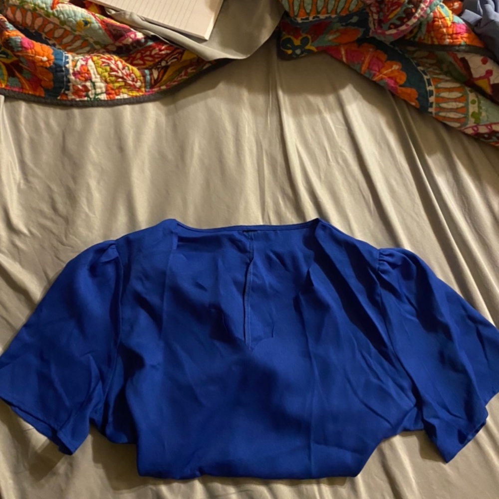 Beautiful blue blouse with a scalloped neckline.